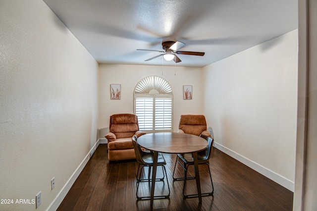 dining space featuring ceiling fan and dark hardwood / wood-style flooring