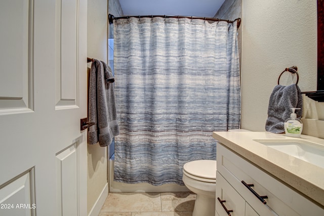 full bathroom featuring vanity, shower / tub combo, toilet, and tile patterned floors