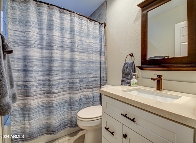 bathroom featuring vanity, toilet, and walk in shower