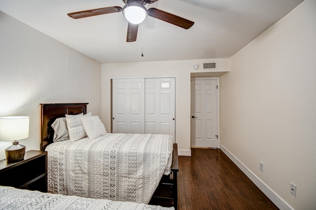 bedroom with ceiling fan, a closet, and dark wood-type flooring