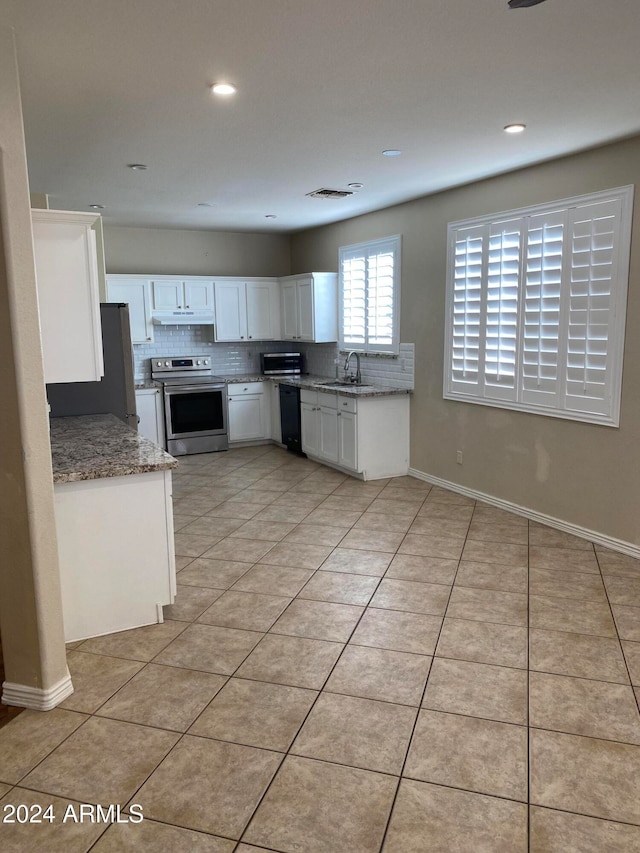 kitchen featuring sink, dishwasher, electric range, white cabinetry, and light tile patterned floors