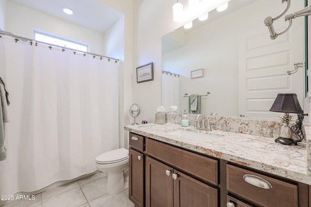 bathroom featuring tile patterned flooring, vanity, and toilet