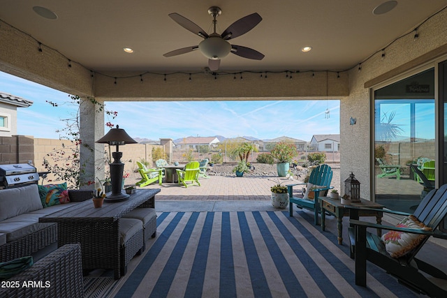 view of patio with ceiling fan, an outdoor living space, and grilling area