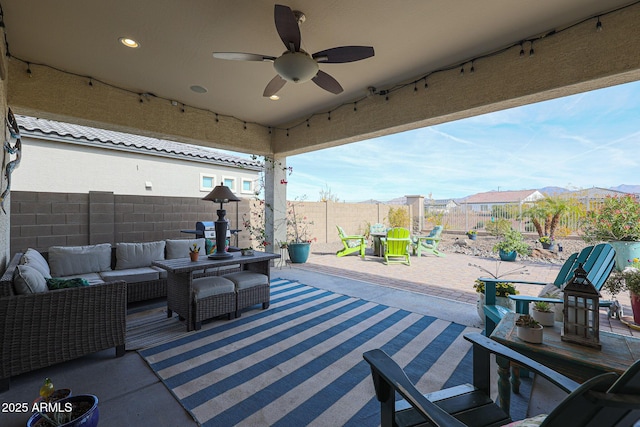 view of patio with a mountain view, outdoor lounge area, and ceiling fan