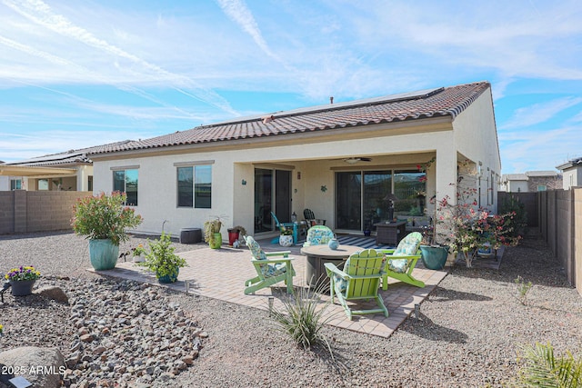 rear view of house with a patio area and an outdoor living space with a fire pit