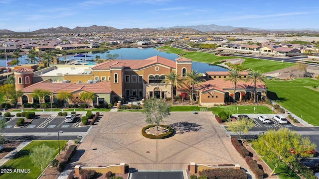 birds eye view of property with a water and mountain view