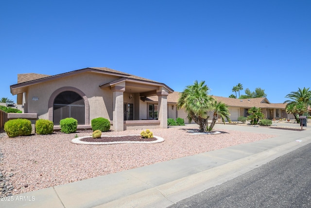 13721 W Franciscan Dr, Sun City West, AZ 85375 - view of front facade with an attached garage, stucco siding, and driveway