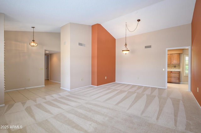 13721 W Franciscan Dr, Sun City West, AZ 85375 - spare room with light carpet, high vaulted ceiling, baseboards, and light tile patterned flooring