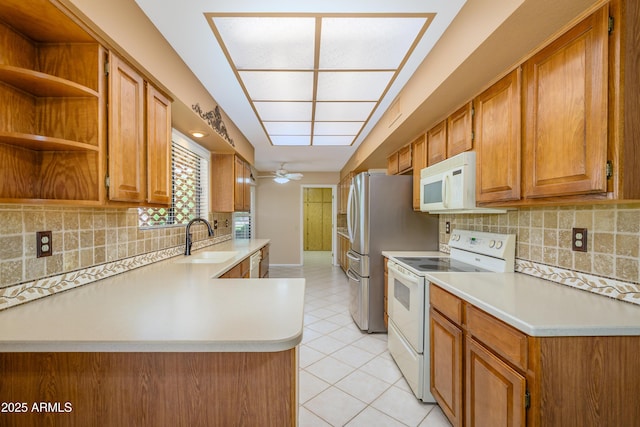 13721 W Franciscan Dr, Sun City West, AZ 85375 - kitchen featuring white appliances, a sink, light countertops, and backsplash