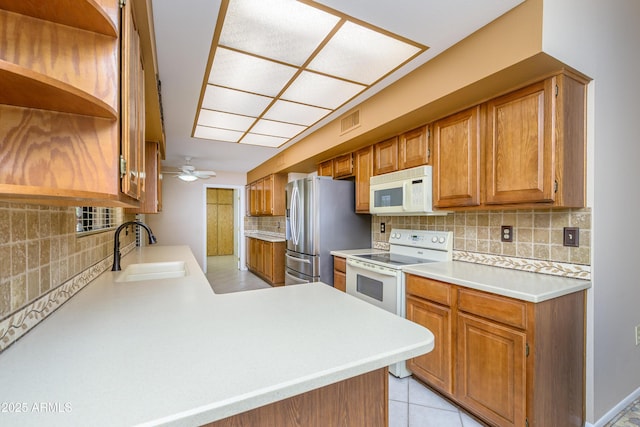 13721 W Franciscan Dr, Sun City West, AZ 85375 - kitchen with white appliances, open shelves, a sink, decorative backsplash, and a peninsula