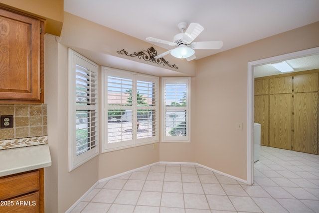 13721 W Franciscan Dr, Sun City West, AZ 85375 - unfurnished dining area featuring healthy amount of natural light, light tile patterned flooring, ceiling fan, and baseboards