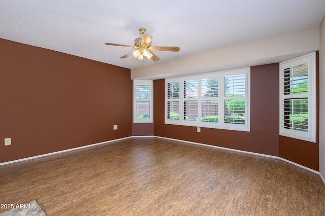 13721 W Franciscan Dr, Sun City West, AZ 85375 - spare room with wood finished floors, a ceiling fan, and baseboards