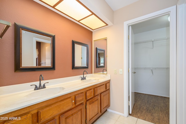 13721 W Franciscan Dr, Sun City West, AZ 85375 - full bathroom featuring double vanity, tile patterned floors, and a walk in closet