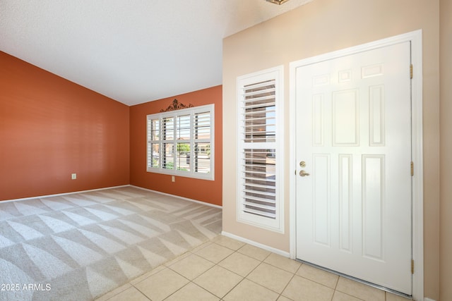 13721 W Franciscan Dr, Sun City West, AZ 85375 - entrance foyer with light carpet, baseboards, and light tile patterned flooring