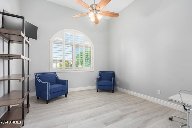 living area with light wood-type flooring and ceiling fan