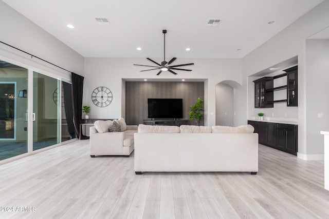 living room featuring light wood-type flooring and ceiling fan