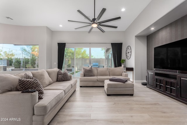 living room with ceiling fan and light hardwood / wood-style floors