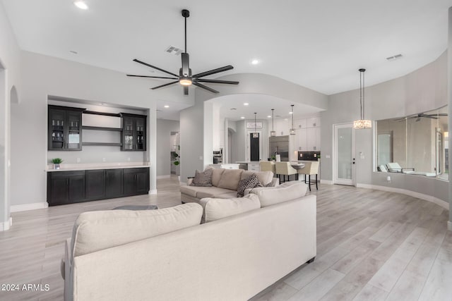 living room featuring light hardwood / wood-style flooring and ceiling fan