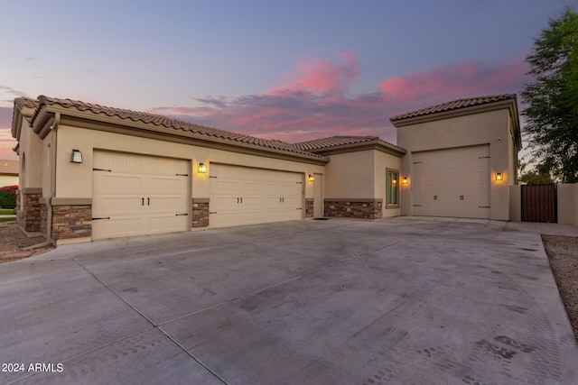 mediterranean / spanish-style home with a garage