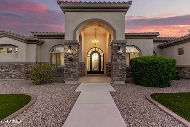 view of exterior entry at dusk