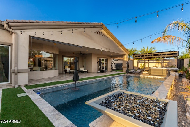 view of swimming pool with ceiling fan, an outdoor fire pit, and a patio area