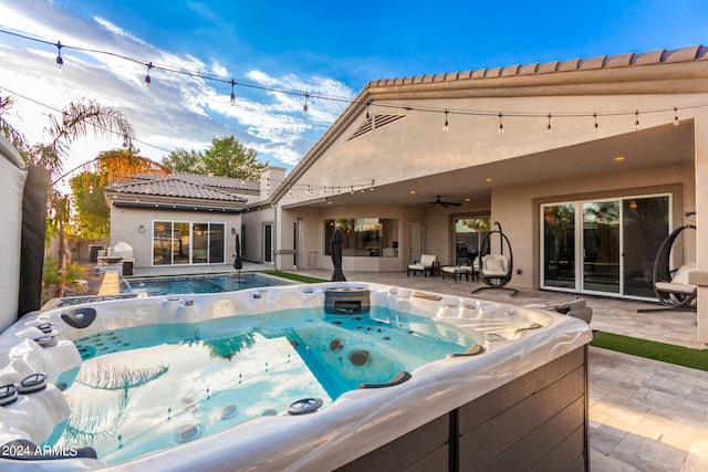 view of pool with ceiling fan, a patio area, and a hot tub