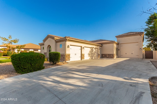 mediterranean / spanish home with a garage