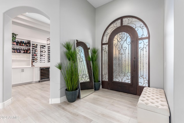 foyer featuring light hardwood / wood-style flooring and beverage cooler