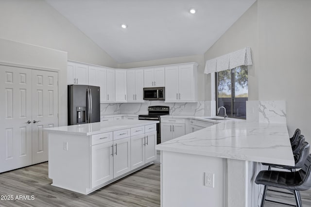 11257 E Reginald Ave, Mesa, AZ 85212 - kitchen featuring fridge with ice dispenser, stainless steel microwave, vaulted ceiling, range with electric cooktop, and a peninsula