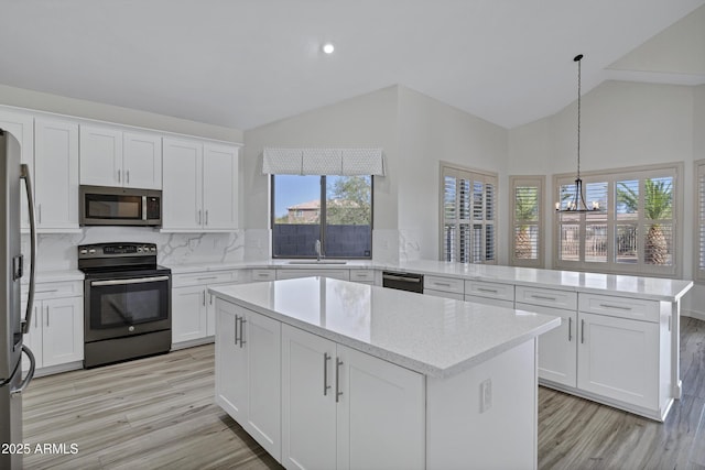 11257 E Reginald Ave, Mesa, AZ 85212 - kitchen featuring appliances with stainless steel finishes, a chandelier, a peninsula, light wood-style floors, and a kitchen island