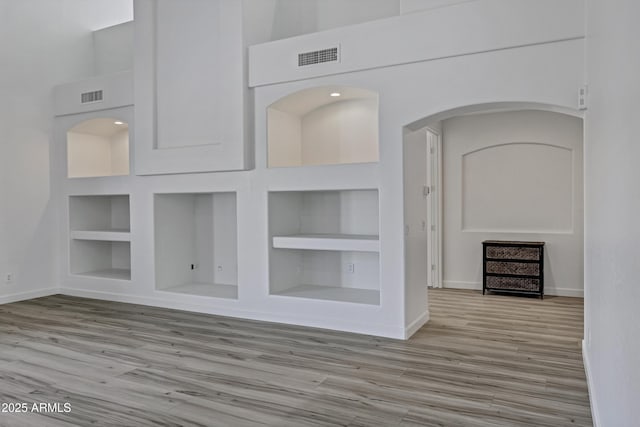 11257 E Reginald Ave, Mesa, AZ 85212 - corridor with built in features, wood finished floors, a towering ceiling, and arched walkways