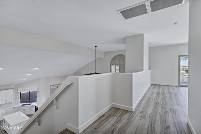 11257 E Reginald Ave, Mesa, AZ 85212 - hallway with an upstairs landing, light wood finished floors, healthy amount of natural light, and recessed lighting
