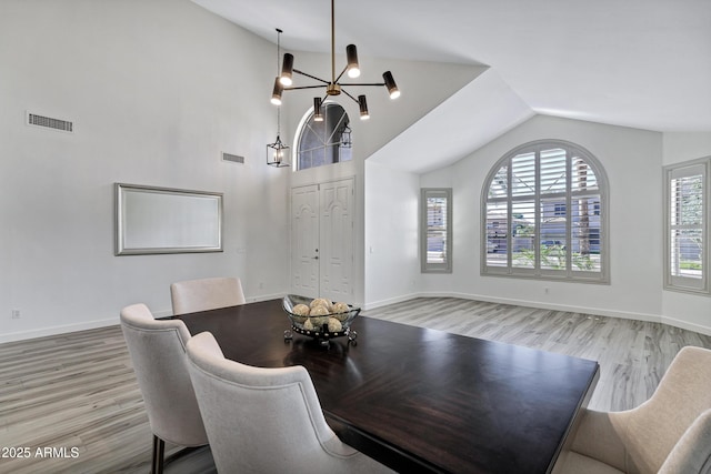 11257 E Reginald Ave, Mesa, AZ 85212 - dining room featuring lofted ceiling, wood finished floors, and a chandelier