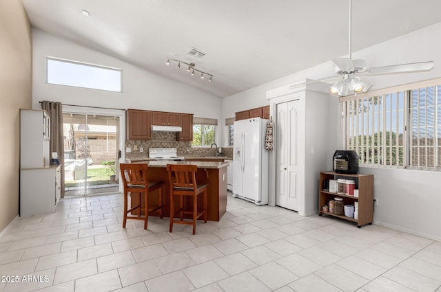 1950 E Kings Ave, Phoenix, AZ 85022 - kitchen with white appliances, lofted ceiling, a sink, a center island, and under cabinet range hood