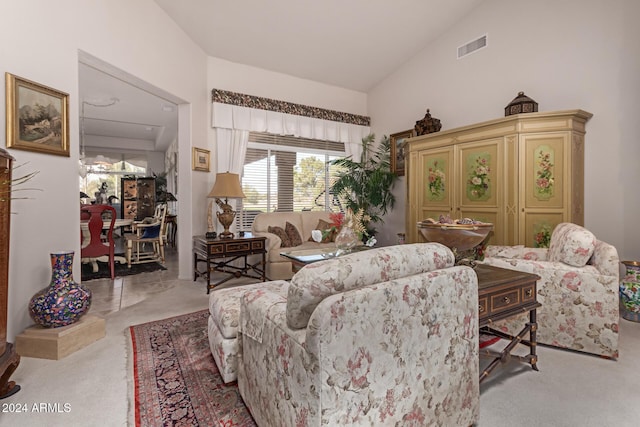 carpeted living room with vaulted ceiling