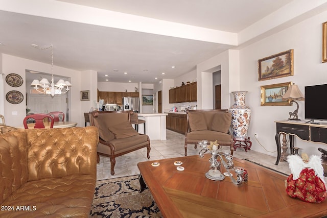 tiled living room with a notable chandelier