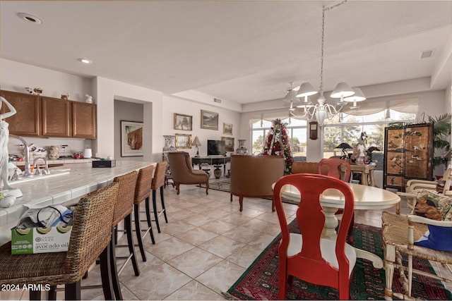 dining space featuring a notable chandelier and light tile patterned floors