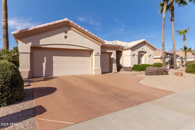 mediterranean / spanish-style home with a garage