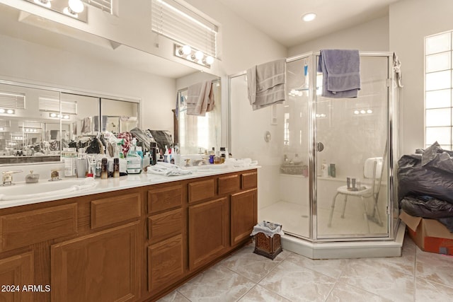 bathroom featuring vanity and a shower with shower door