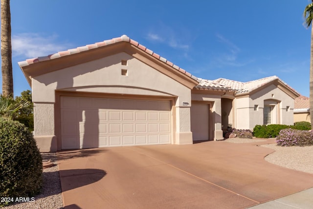 mediterranean / spanish home with a garage