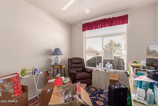 sitting room featuring ceiling fan