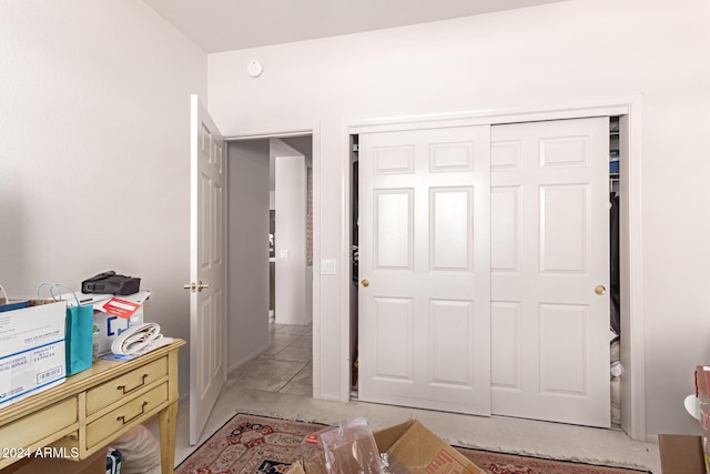 tiled bedroom with a closet