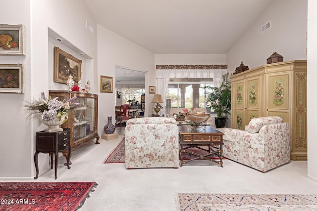 living room with light colored carpet and vaulted ceiling