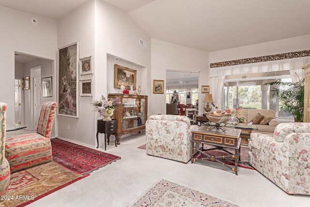 carpeted living room featuring vaulted ceiling