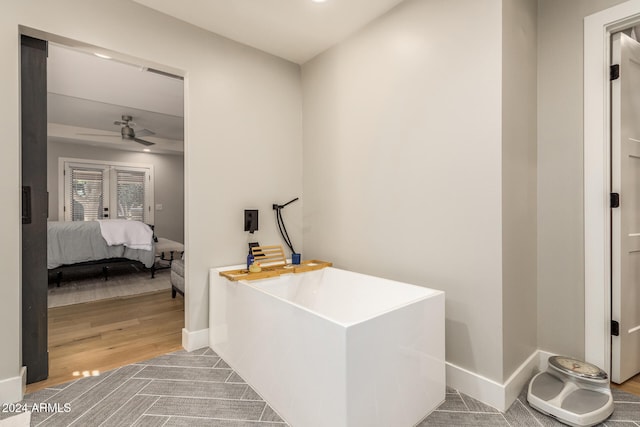 bathroom with ceiling fan and wood-type flooring