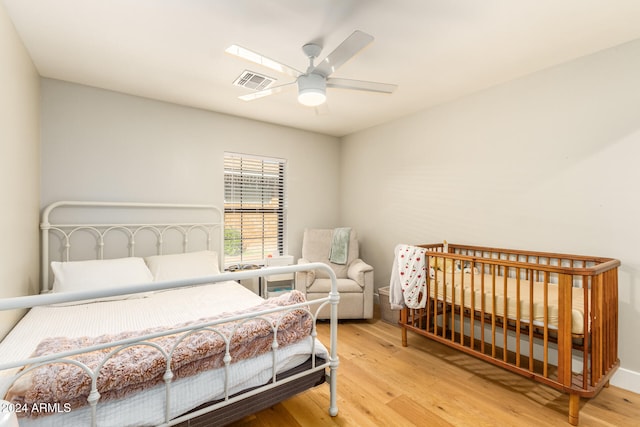 bedroom featuring light hardwood / wood-style floors and ceiling fan