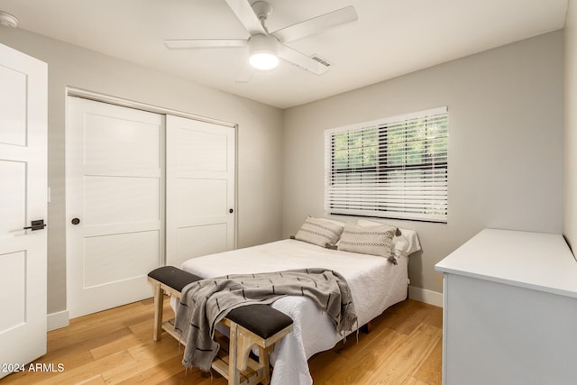 bedroom featuring a closet, light wood-type flooring, and ceiling fan