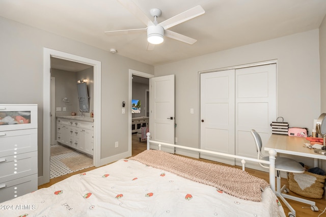 bedroom featuring hardwood / wood-style flooring, ensuite bathroom, a closet, and ceiling fan