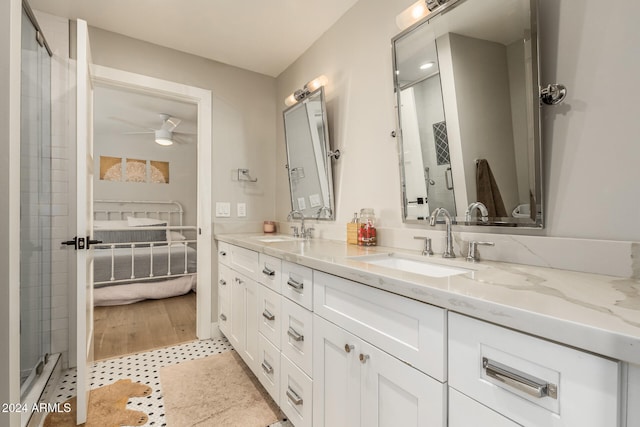 bathroom featuring a shower with door, vanity, and wood-type flooring