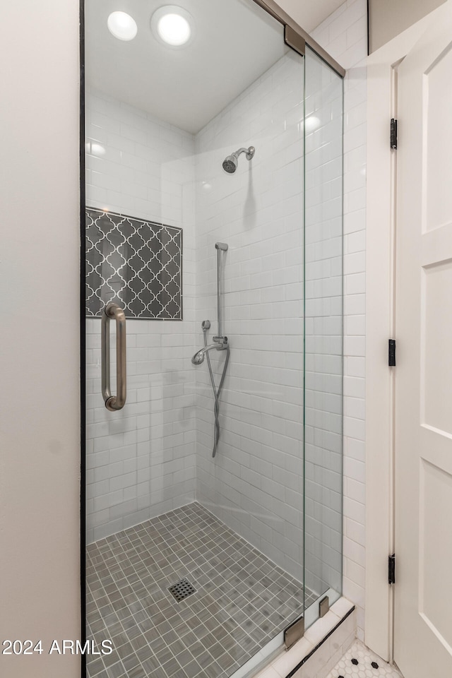 bathroom with walk in shower and tile patterned floors